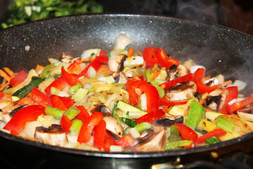 A close-up of  vegetables being stir-fried  in a frying pan for the Korean beef stir fry dish bulgogi.