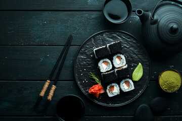 Sushi rolls -Fila Black with black caviar, salmon and cheese. Top view. Free space for your text.