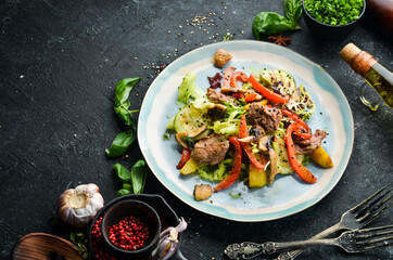 Salad with veal, mushrooms and zucchini. Top view. Rustic style.