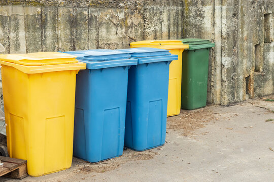 Blue and yellow trash cans or garbage bins
