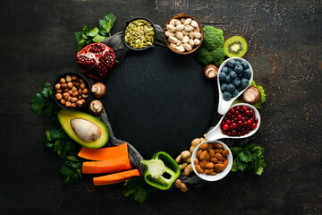 Food background: fruits, vegetables and berries on the old kitchen table. Top view. Rustic style.