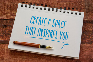 create a space that inspires you - inspirational writing in a spiral notebook with a stylish pen against weathered barn wood table, business and working from home concept