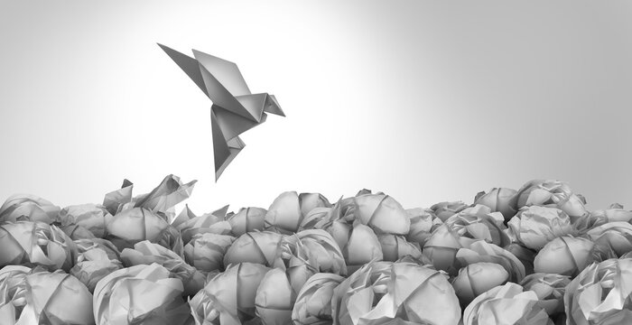 Exit Strategy freedom solution concept as a business plan idea for a contingency plan to leave and prosper elsewhere as a group of crumpled paper with one transforming into an origami bird escaping