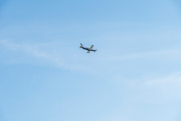 Small airplane on blue sky