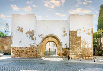 Entrance through medieval walls to historic downtown of Faro, Algarve, Portugal