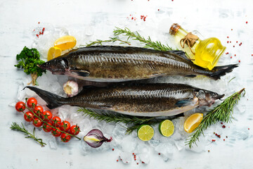 Sturgeon fish with rosemary and spices on a white kitchen background. Top view. Flat lay.