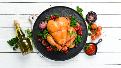 Baked chicken with vegetables and cranberries. Festive traditional food. Thanksgiving day. Top view. Free space for your text.