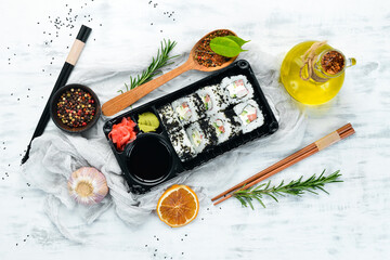 Food delivery. Sushi rolls with caviar and crab. Soy sauce, wasabi. Top view. free space for your...