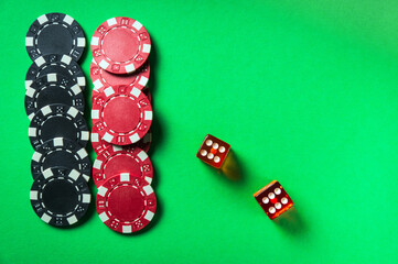 Poker dice with winning combination of eleven on green table and chips. Club atmosphere while playing Craps