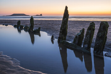Wreck of Helvetia at sunset Rhossili Bay, no people. Gower Peninsula, South Wales, UK