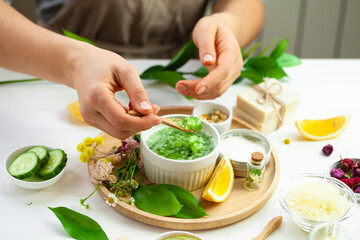 Girl in process of preparation of homemade refreshing cucumber mask. Self care, home face and body treatment durine lockdown. Concept of natural organic ingredients and essential oil in cosmetics