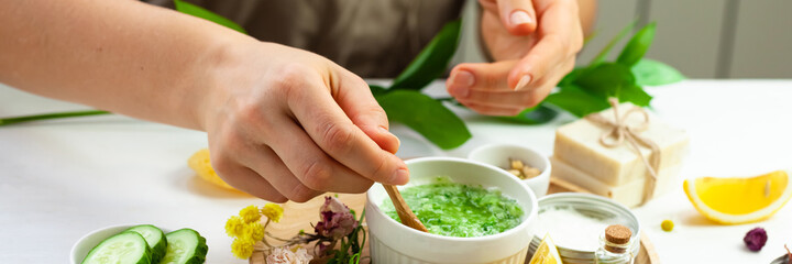 Girl in process of preparation of homemade refreshing cucumber mask. Self care, home face and body treatment durine lockdown. Concept of natural organic ingredients and essential oil. Banner