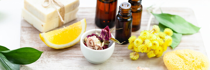 Concept of spa treatment with natural organic products. Essential oil, herbal and flower extracts, fresh plants. Atmosphere of relaxation, zen, aromatherapy. Homemade skin and body care. Banner