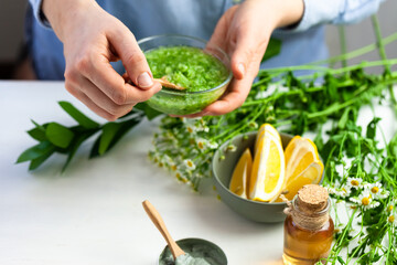 Girl in process of preparation of homemade refreshing cucumber mask. Self care, home face and body treatment durine lockdown. Concept of natural organic ingredients and essential oil in cosmetics