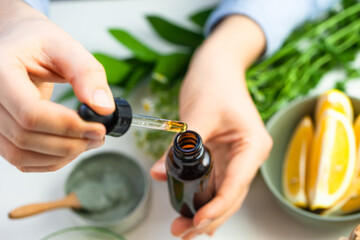 Woman performing professional cosmetics research. Concept of natural organic ingredients in dermatology. Essential oil, extract of herbs, fruits, vegetables. Natural moisturizing body, face care.