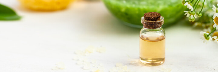 Concept of natural organic ingredients in cosmetics. Essential oil, extract of fruits and vegetables. Natural moisturizing body, face care. Camomile essence for healthy young skin. Banner close up