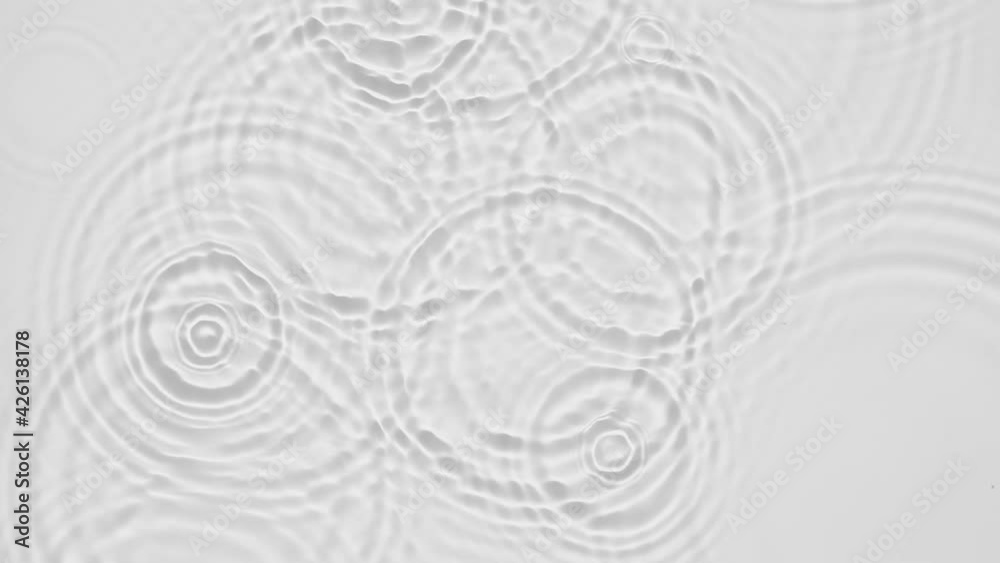 Poster up close, top view, slow motion various waves of the water surface hitting the sun's rays, making th