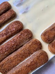 coffee-soaked sponge cakes for tiramisu, savoiardi sponge cakes, bowl lined with sponge cakes, mascarpone cream, tiramisu' dessert