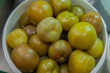 Selling salted green tomatoes at the vegetable market