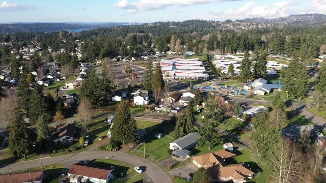Cinematic aerial drone dolly footage of the Meadow Crest Early Learning Center with Renton, Highlands Park, residential Seattle neighborhoods in King County, near Seattle, Washington