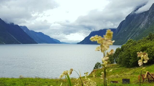 Windy day in a Norwegian fjord, mountain coastline in bad weather