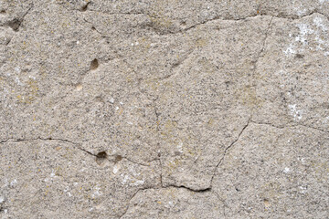 Very old, cracked wall, gray concrete texture.