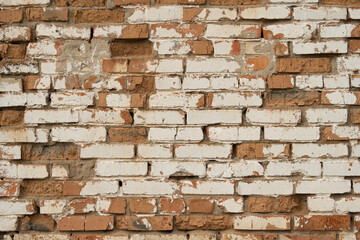 Old repaired weathered brick wall for background.