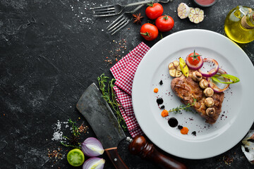 Grilled pork steak with sauce on a plate. Top view. Free copy space.