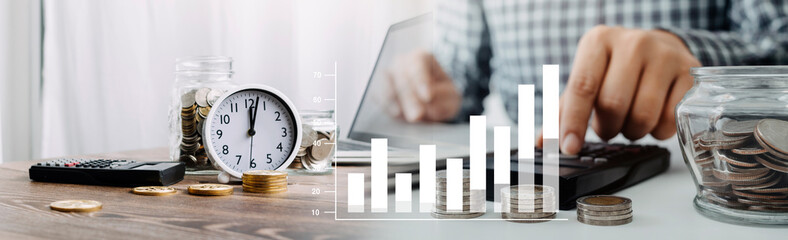 businessman holding coins putting in glass and using calculator. concept saving money and finance accounting.