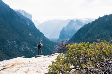 Fototapeta na wymiar Man taking pictures in Yosemite National park