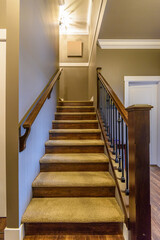 Beautiful living room interior with hardwood floors in new luxury home. View of stairs, and second story area.
