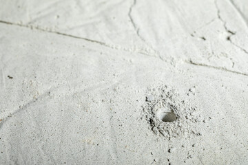 Drilled hole in concrete for a dowel close-up.