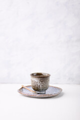 Traditional, handcrafted ceramic on bright wooden background. Soft focus. Copy space.	