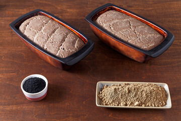 Homemade bread with acorn flour. Two loafs of freshly baked bread at home in clay natural moulds. © Fotema