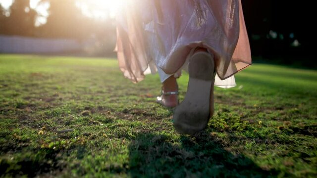 girl feet walking on grass