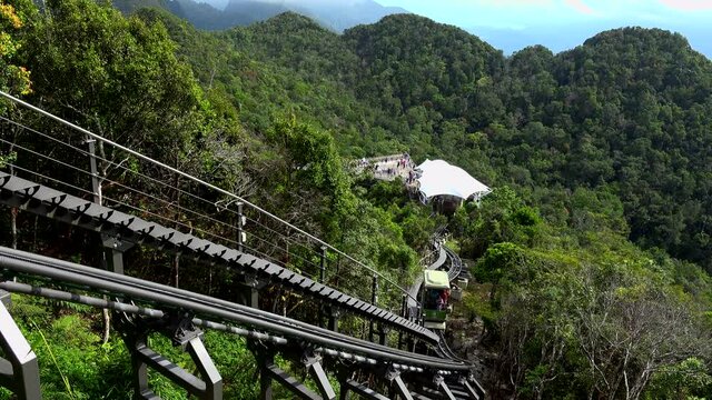 small train going up from langkawi skybridge to the panoramic mountain view.