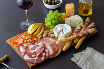 Wine snack. Jamon, camembert, chorizo, almonds, blue cheese, parmesan. Antipasti. Wine appetizer.