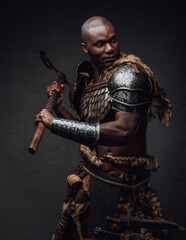 Aggressive and dangerous black skinned barbarian with axe