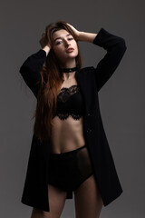 Fototapeta premium Model in total black posing on grey background