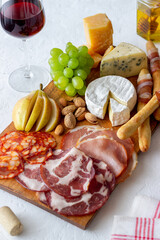 Wine snack. Jamon, camembert, chorizo, almonds, blue cheese, parmesan. Antipasti. Wine appetizer.