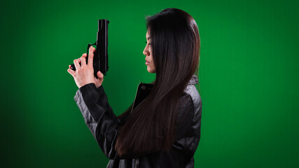 Young female agent with a gun in her hand - studio photography
