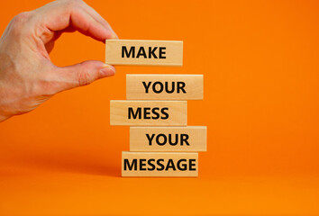 Business concept growth success process. Wood blocks on orange background, copy space. Businessman hand. Words 'make your mess your message'. Conceptual image of motivation.