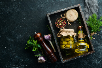 Pickled olives in a glass jar. Food stocks. Top view.