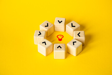 The wooden cubes are standing in a circle. A symbol of the search for an idea. A business concept. strategic thinking