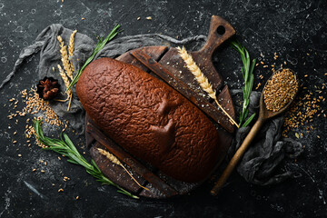 Freshly baked homemade black bread. Baking from rye and flour. Top view. Rustic style.