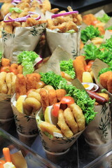 Fish and chips in a paper wrapper for sale