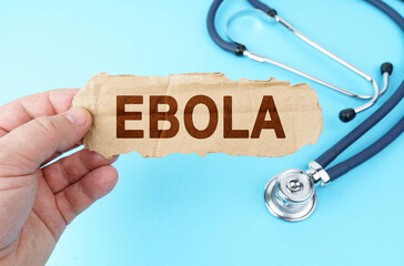 On a blue background, a man holds a cardboard box with the inscription - EBOLA