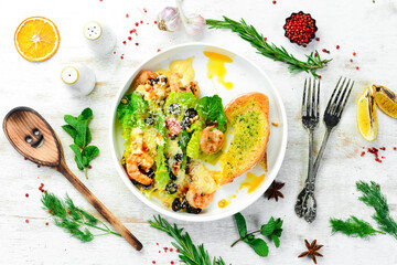 Salad of shrimp, olives, pine nuts and lettuce. Top view. Free space for text.