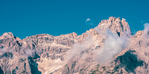 Clouds over mountain peaks in the Dolomites, Italy.