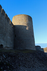 Fototapeta na wymiar medieval Ivngorod fortress wall and tower at the evening